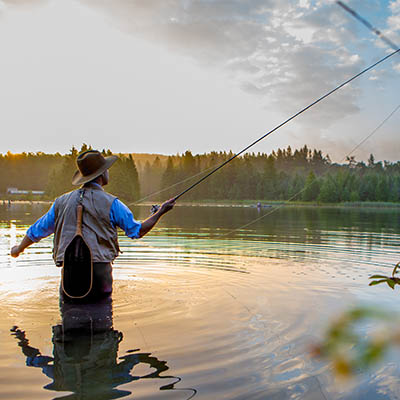 A man fly fishing in a river.